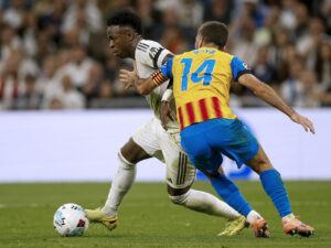 El delantero del Real Madrid Vinicius Jr. (i) se escapa de José Gayá, del Valencia, durante el partido de la jornada 11 de LaLiga que Real Madrid y Valencia CF disputaron en el estadio Santiago Bernabéu. EFE/Javier Lizón