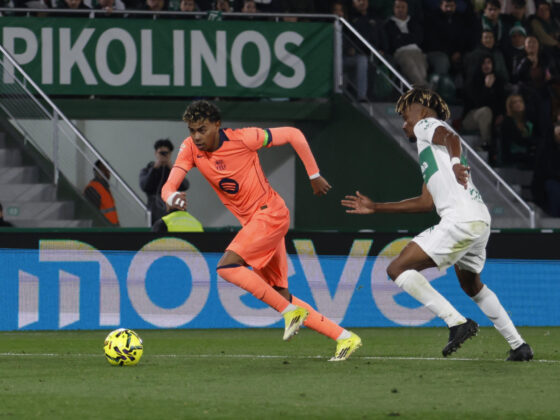 El delantero del FC Barcelona, Lamine Yamal (i), se lleva el balón ante el defensa del Elche, John Donald, durante el encuentro correspondiente a la jornada 22 de la Liga EA Sports que han disputado Elche y FC Barcelona en el estadio Martínez Valero, en la localidad alicantina. EFE / Pablo Miranzo.