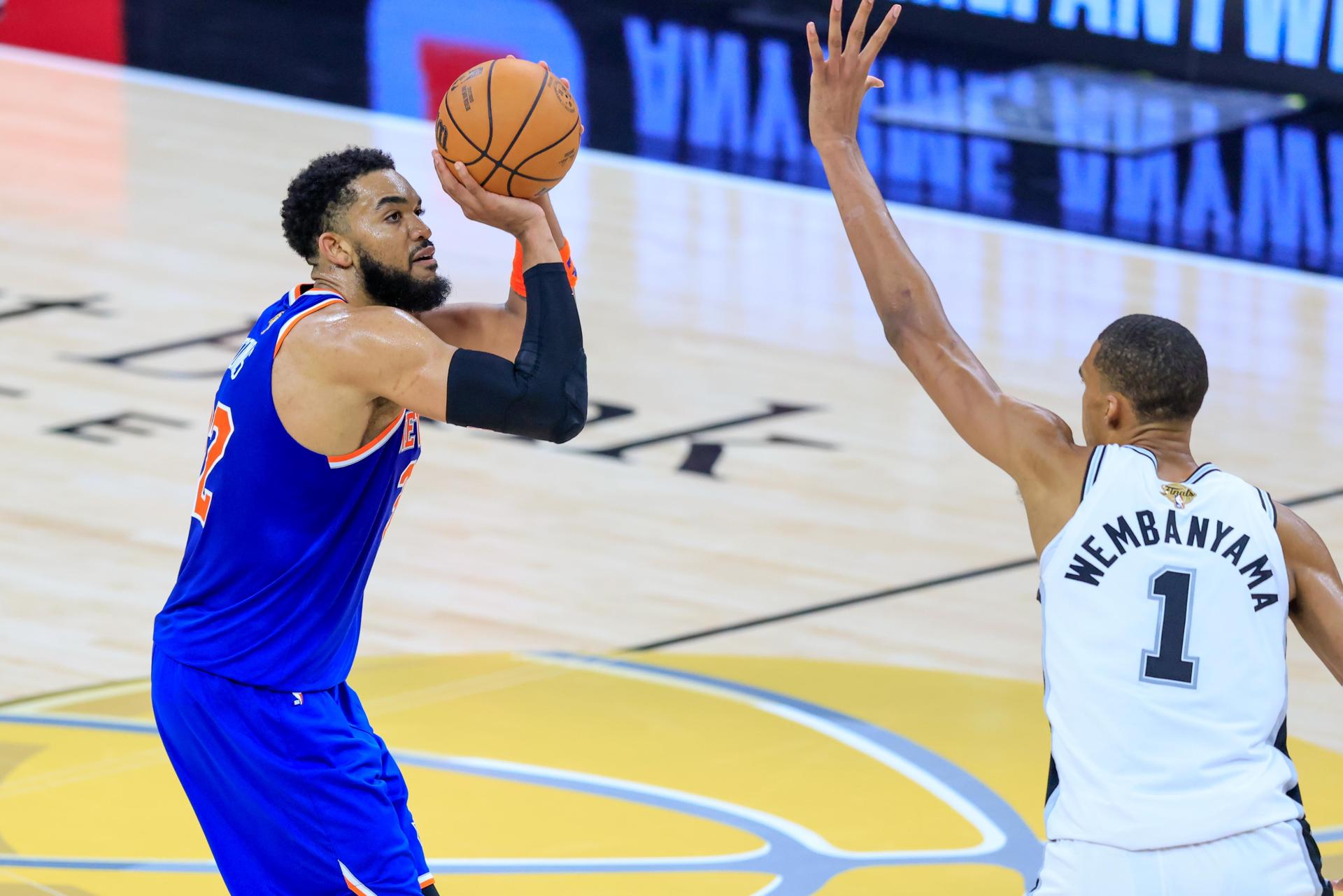 El pívot de los New York Knicks Karl-Anthony Towns (i) tira al aro con la marca del alero de los San Antonio Spurs Victor Wembanyama (d) durante el segundo el partido de las Finales de la NBA entre los San Antonio Spurs y los New York Knicks en San Antonio, Texas (EE.UU.). EFE/ADAM DAVIS PROHIBIDO SU USO EN SHUTTERSTOCK